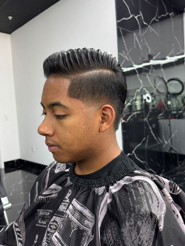 Pompadour with a hard part and skin fade